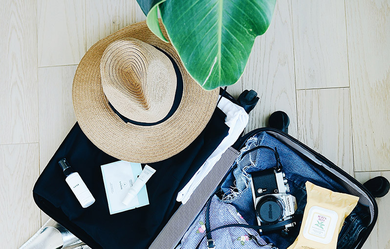 suitcase packed with travel items for a sunny vacation